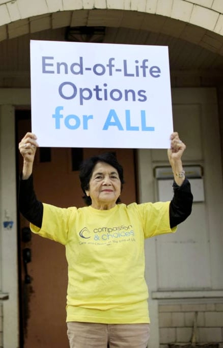 Dolores Huerta holding a End-of-Life Options for all sign