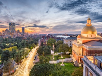 Boston Massachusetts skyline with Capital building in foreground.