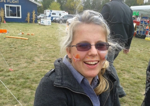 Ana Nelson pictured at a festival smiling with face paint
